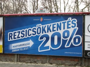 Sign advertising government public utility-fee cuts. 