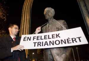 Jobbik Vice-President Előd Novák places sign on statue of Mihály Károlyi: "I Am Responsible for Trianon." 