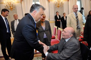 Nobel Prize-winning author Imre Kertész receives congratulations from Prime Minister Viktor Orbán before receiving his 